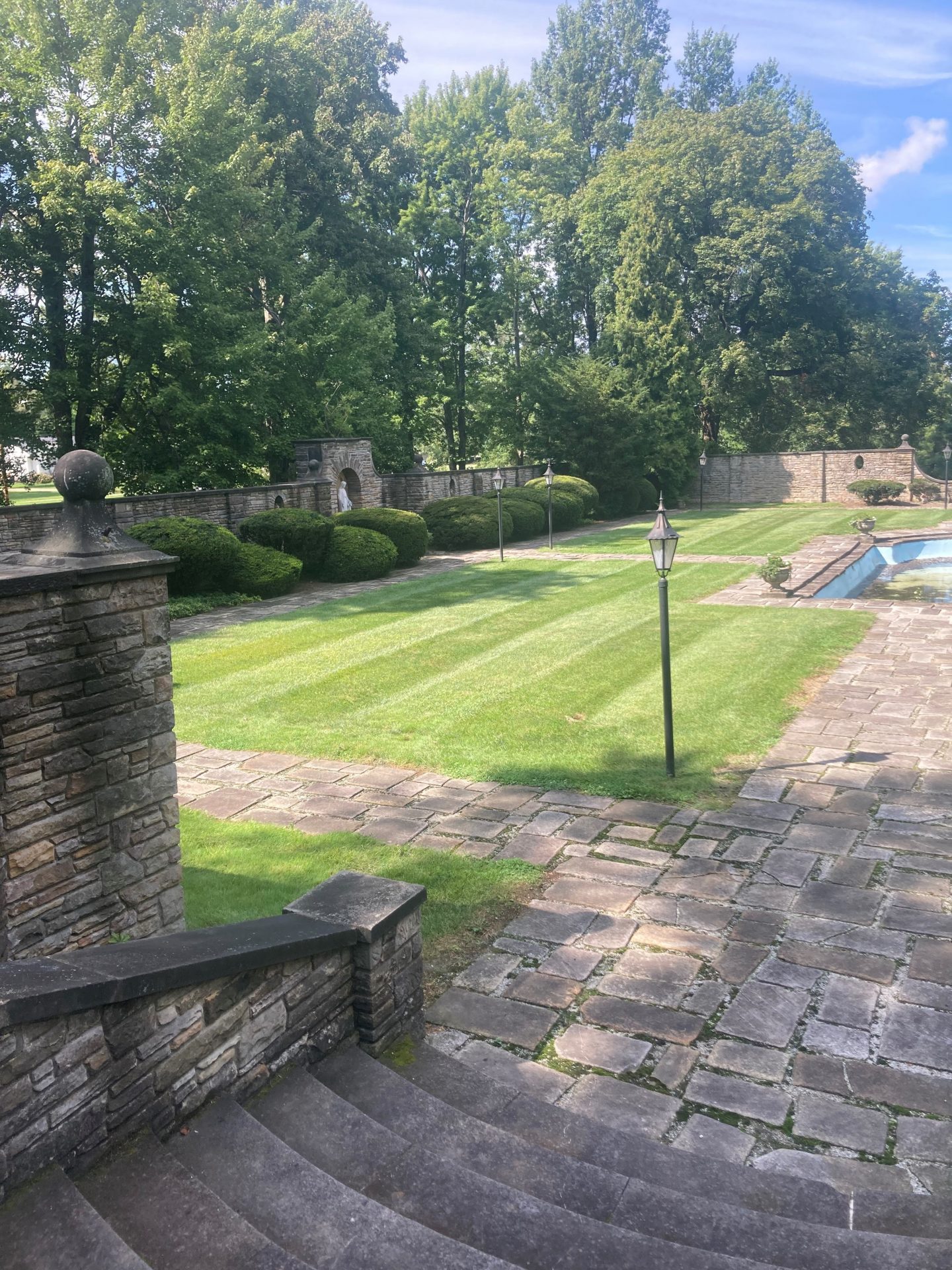 Garden with stone pathways and manicured lawn.