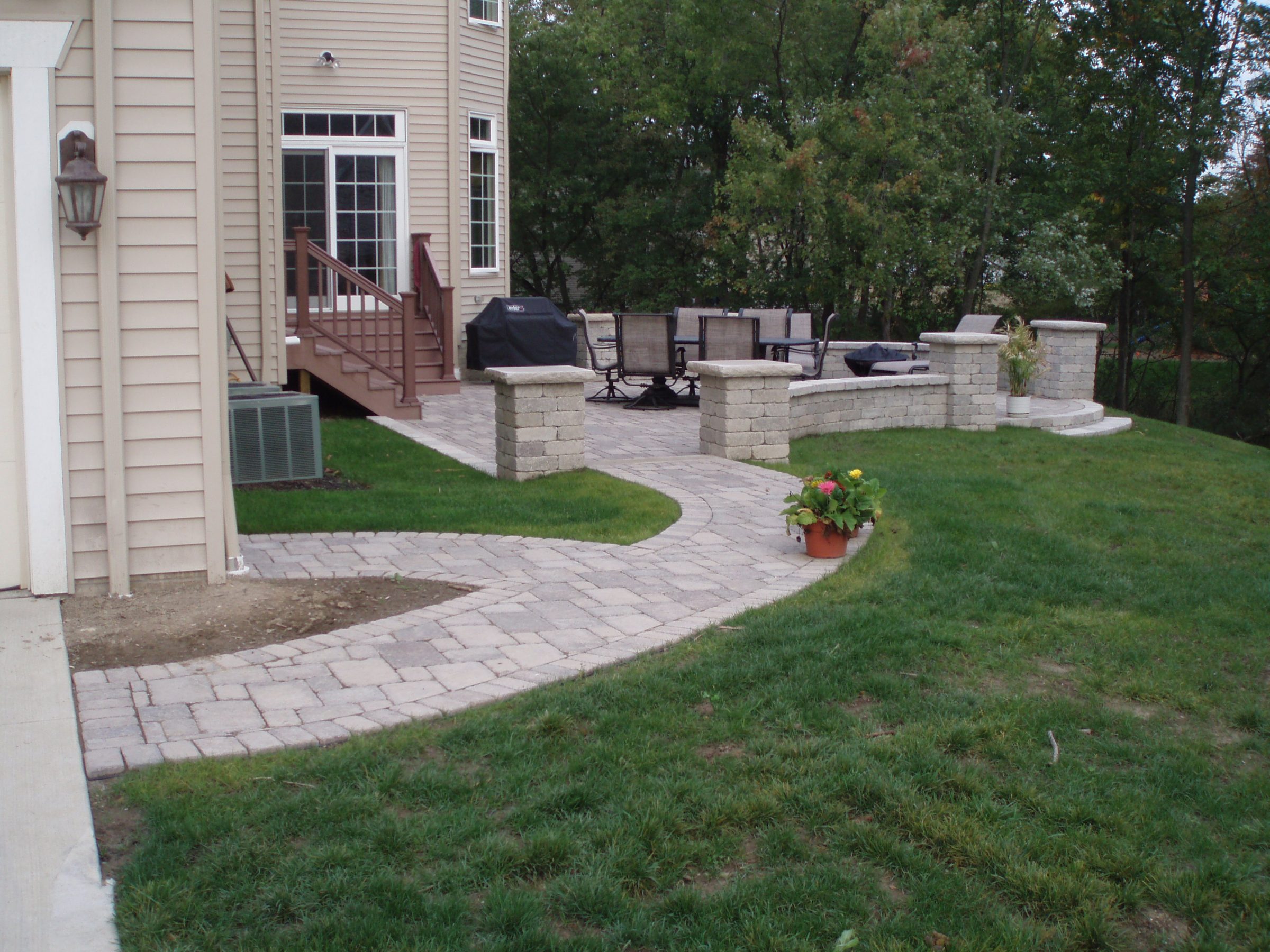 Backyard patio with stone pathway and seating area.