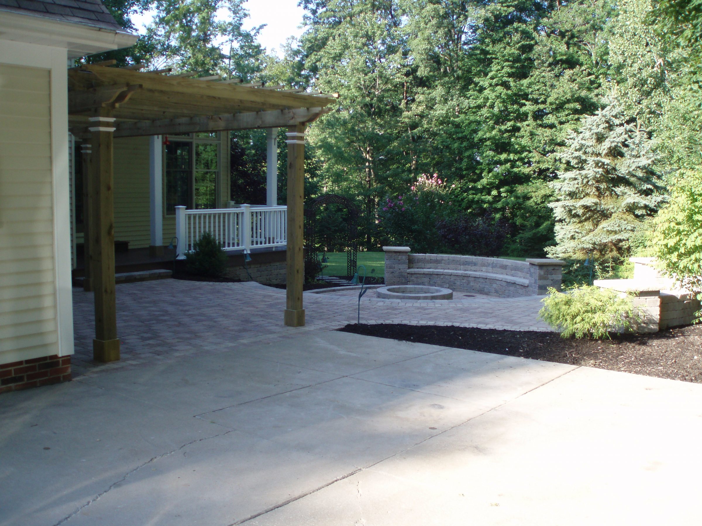 Backyard patio with pergola and fire pit.
