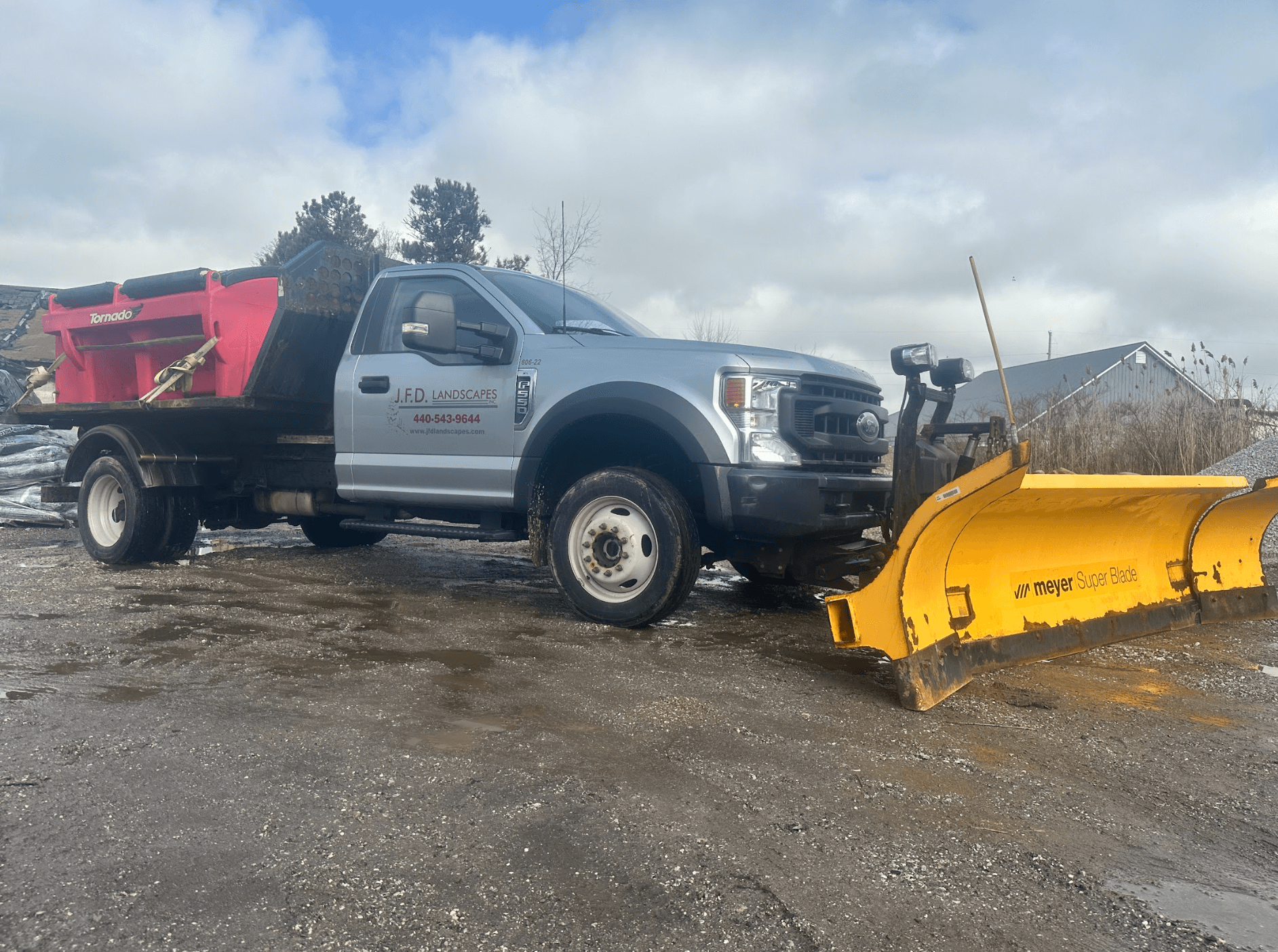 Landscape truck with snow plow and spreader