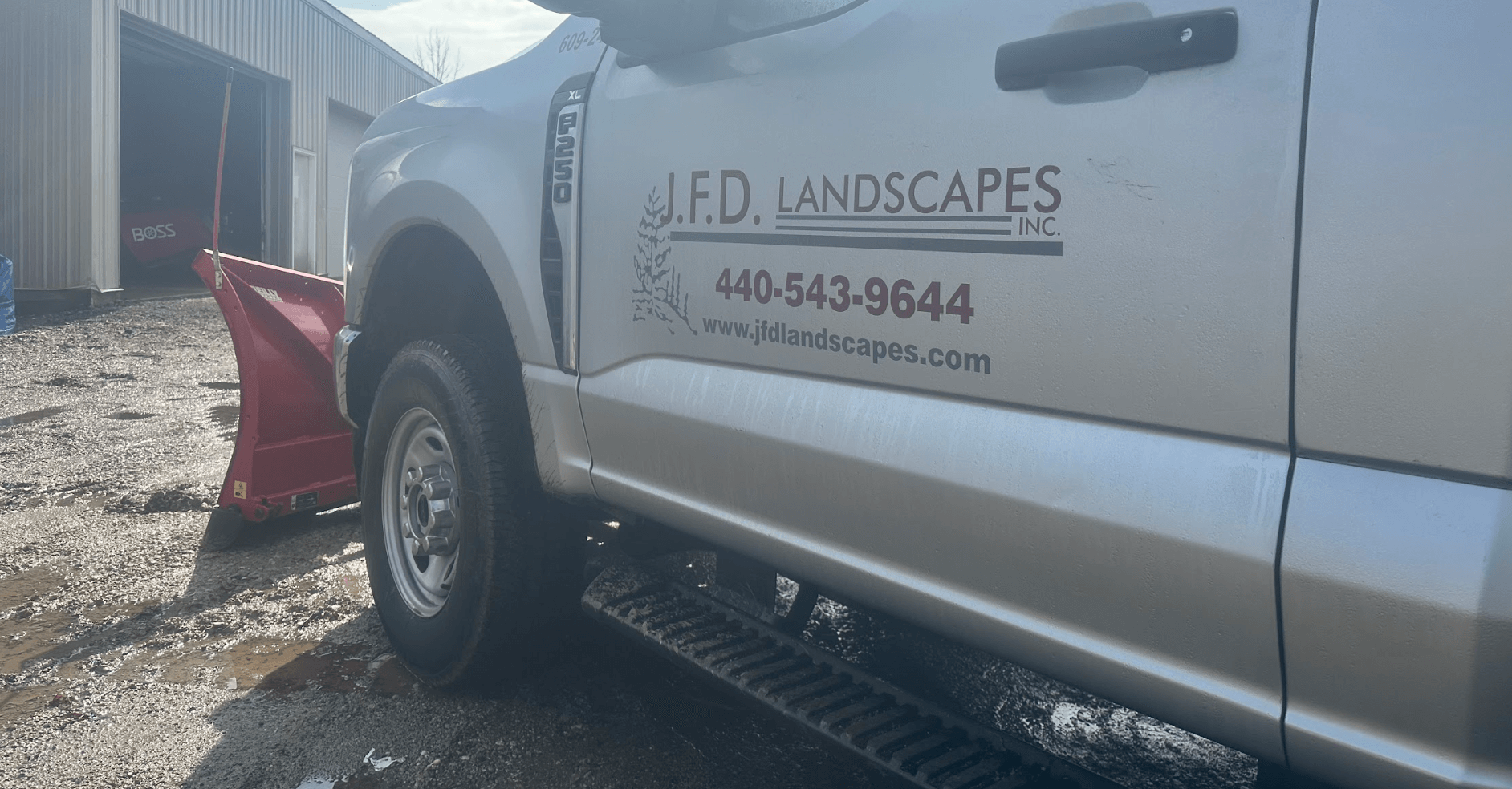 JFD Landscapes truck with snow plow attachment.
