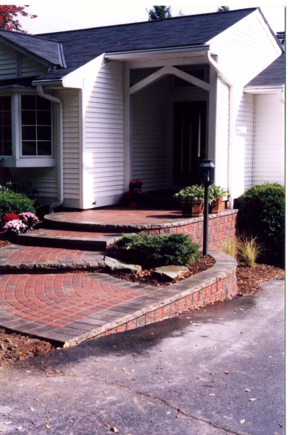 Front entryway with brick steps and landscaping.