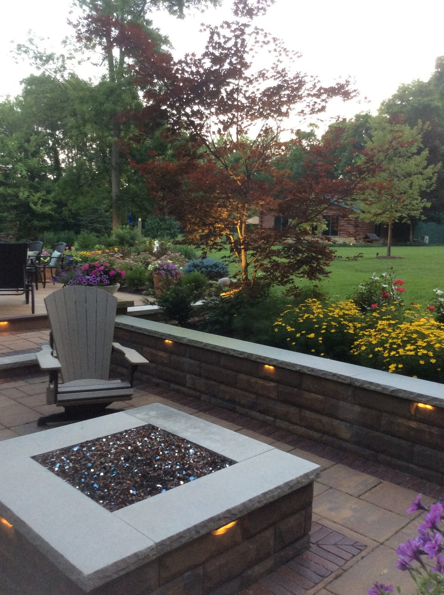 Garden patio with fire pit and flowers