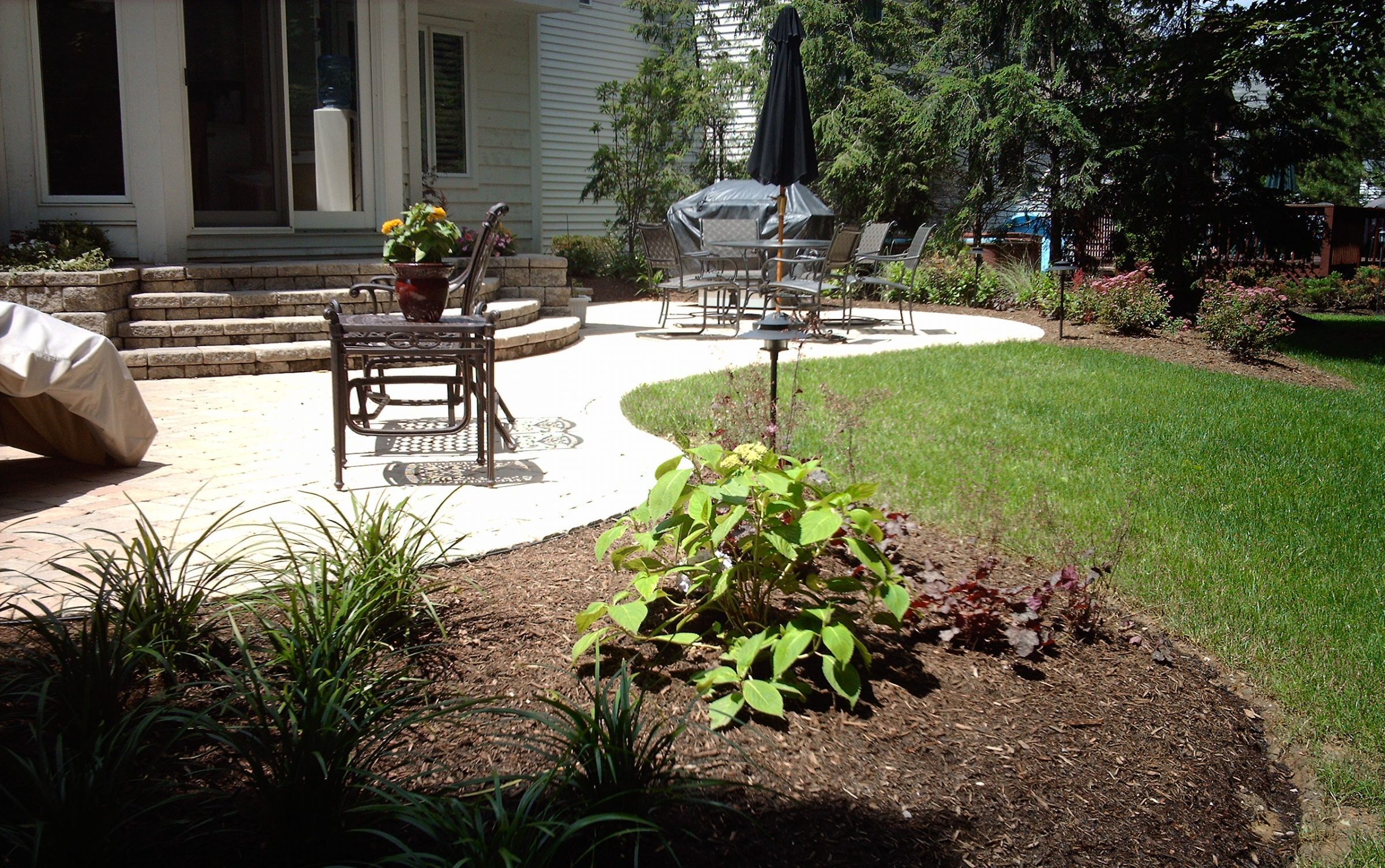 Backyard patio with garden and outdoor furniture