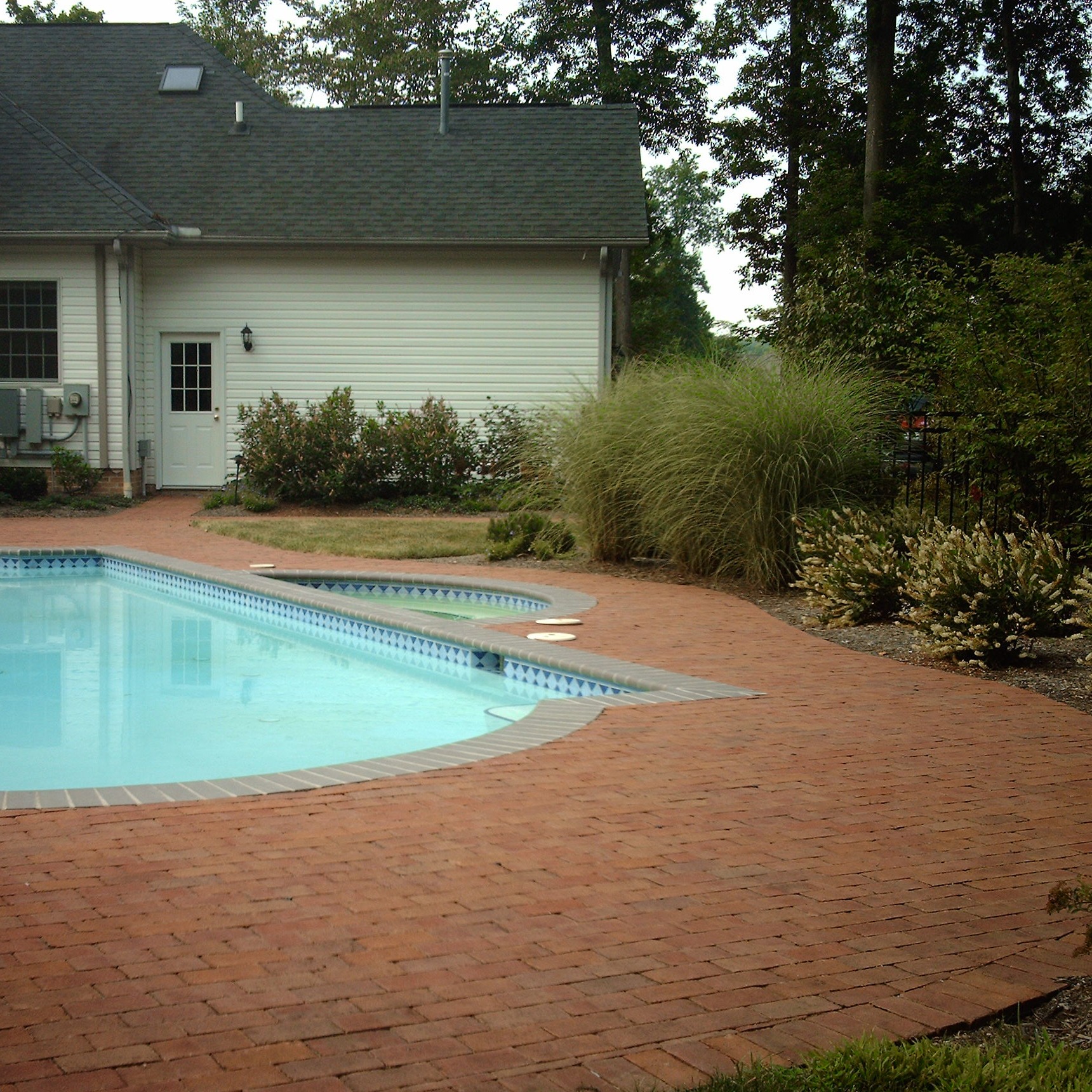 Backyard with pool and brick patio