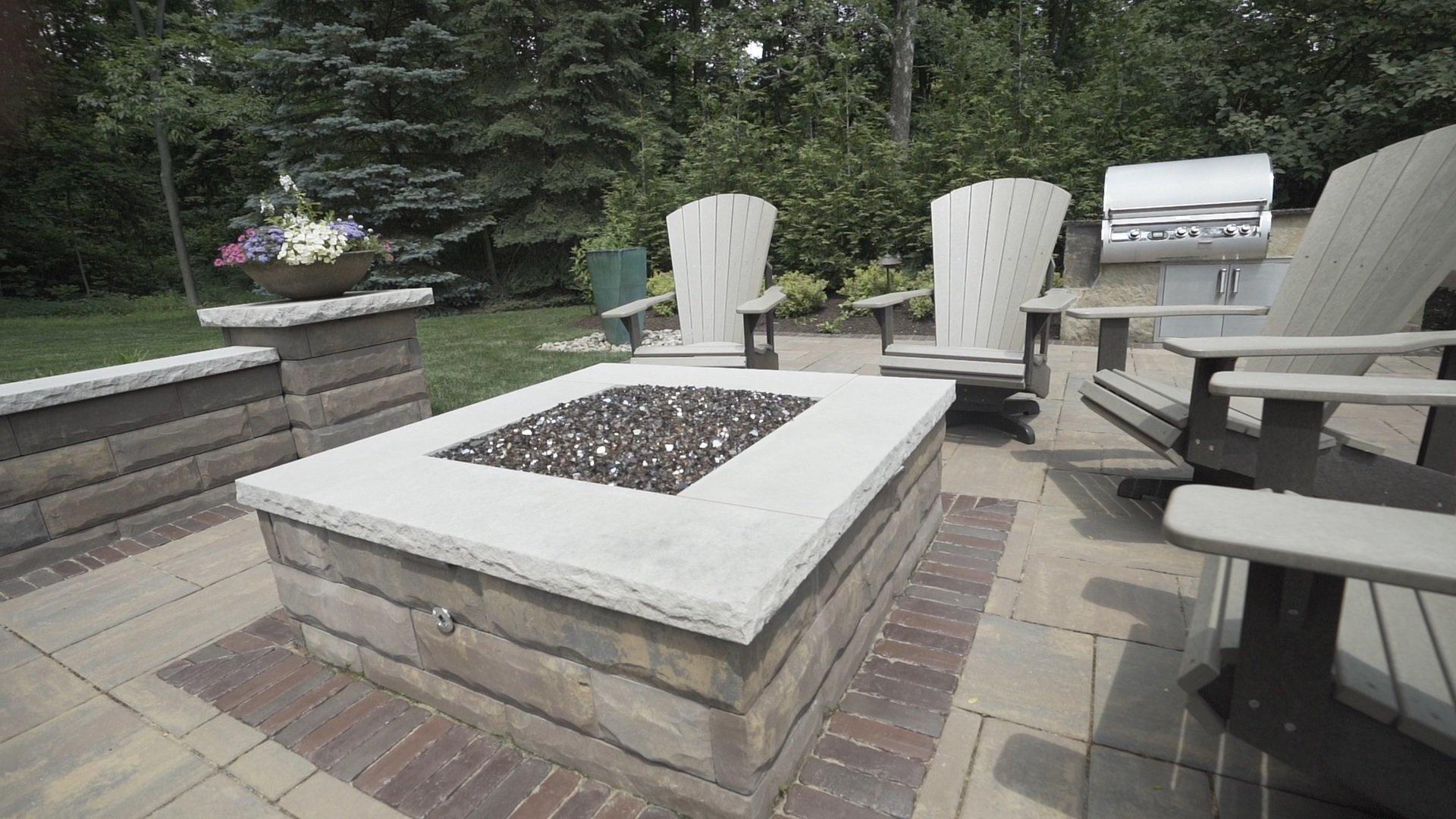 Backyard patio with fire pit and seating area.