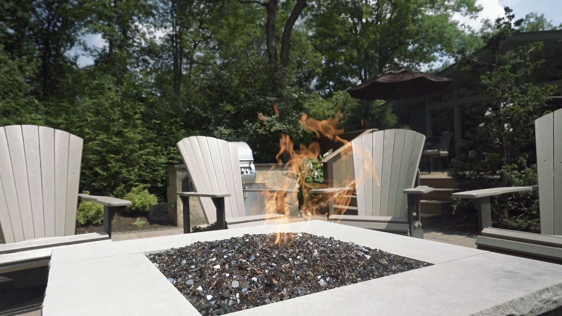 Patio with firepit and outdoor chairs.