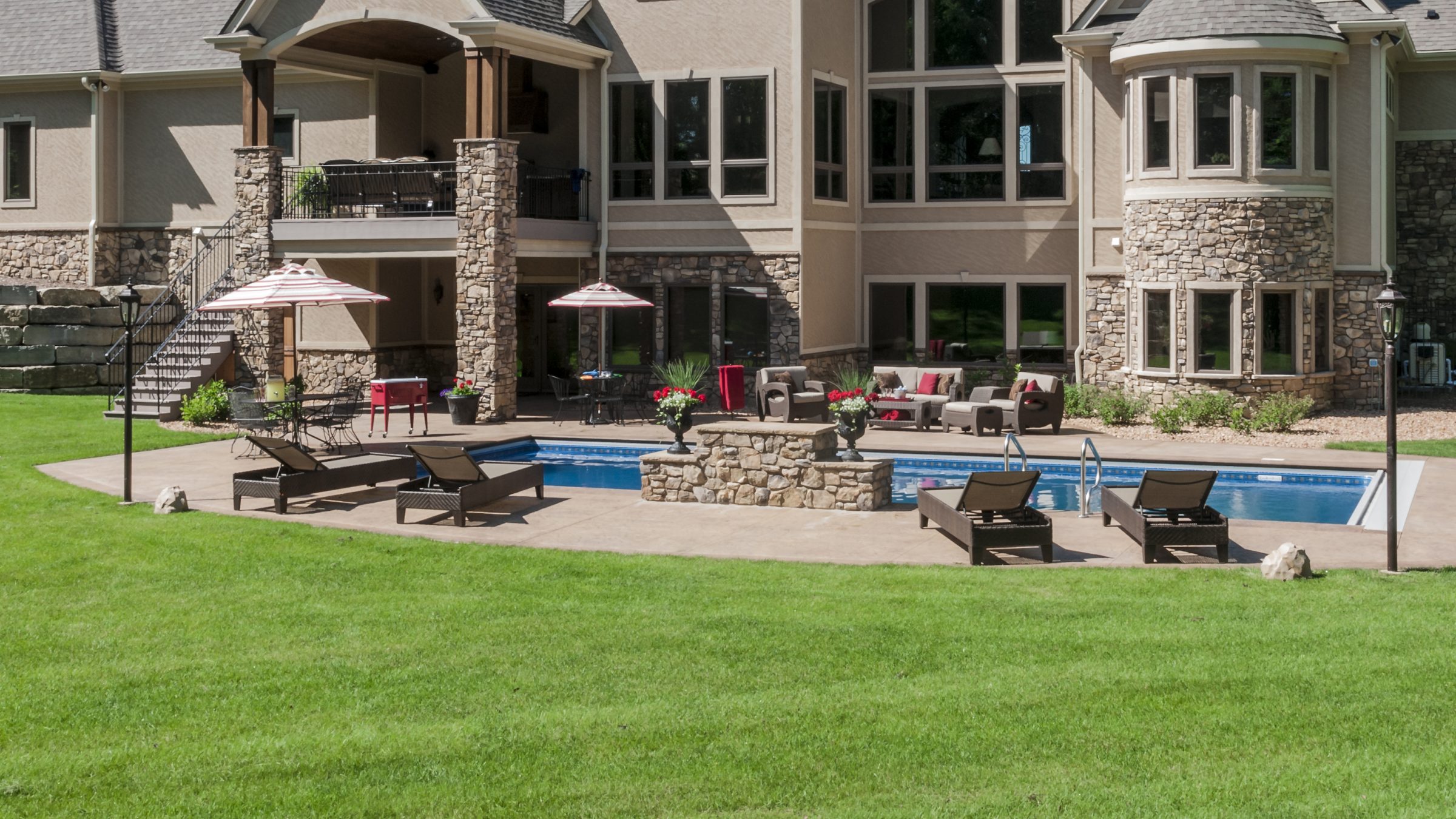 Luxury house with pool and patio furniture.