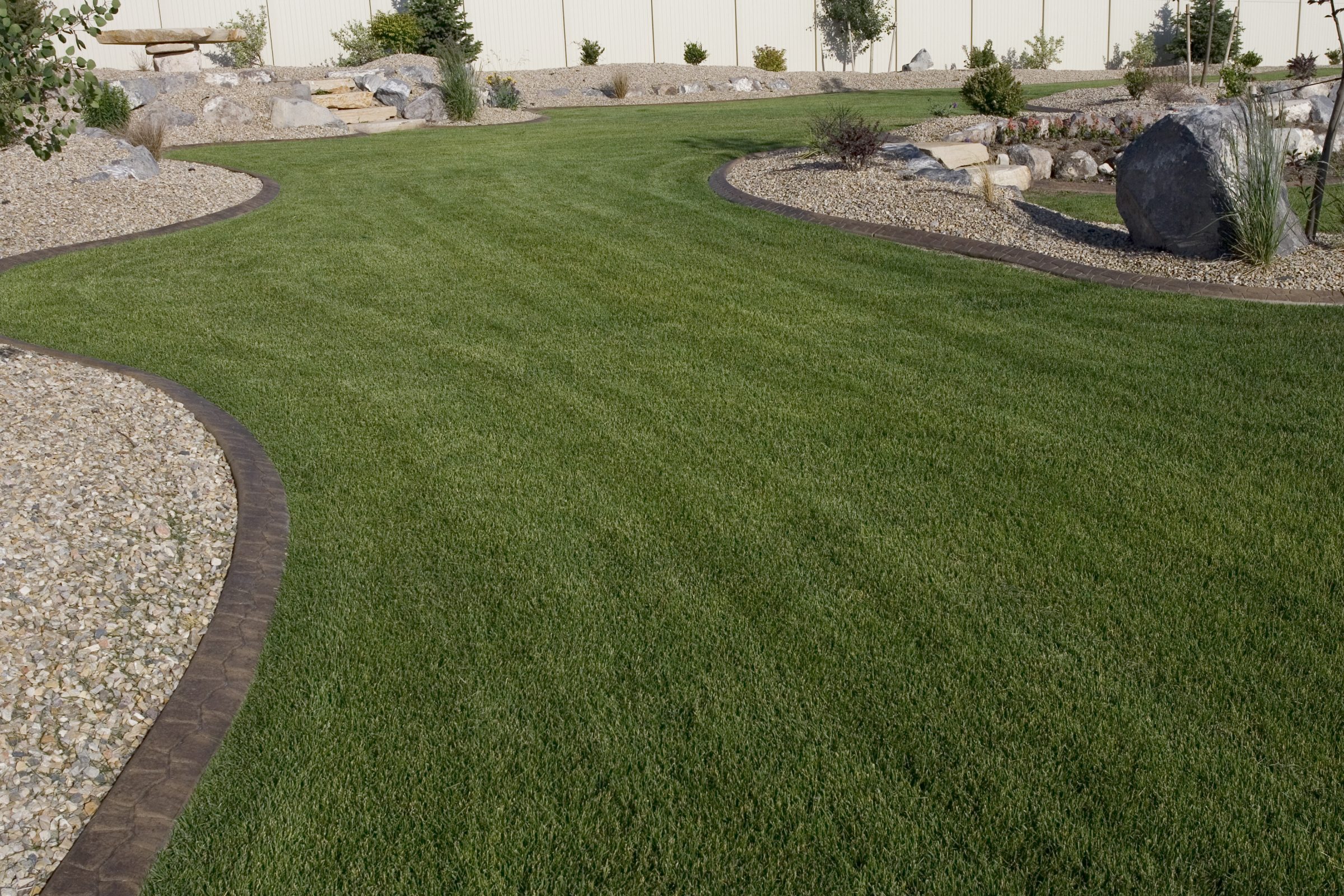 Curved lawn with rock garden and pathway