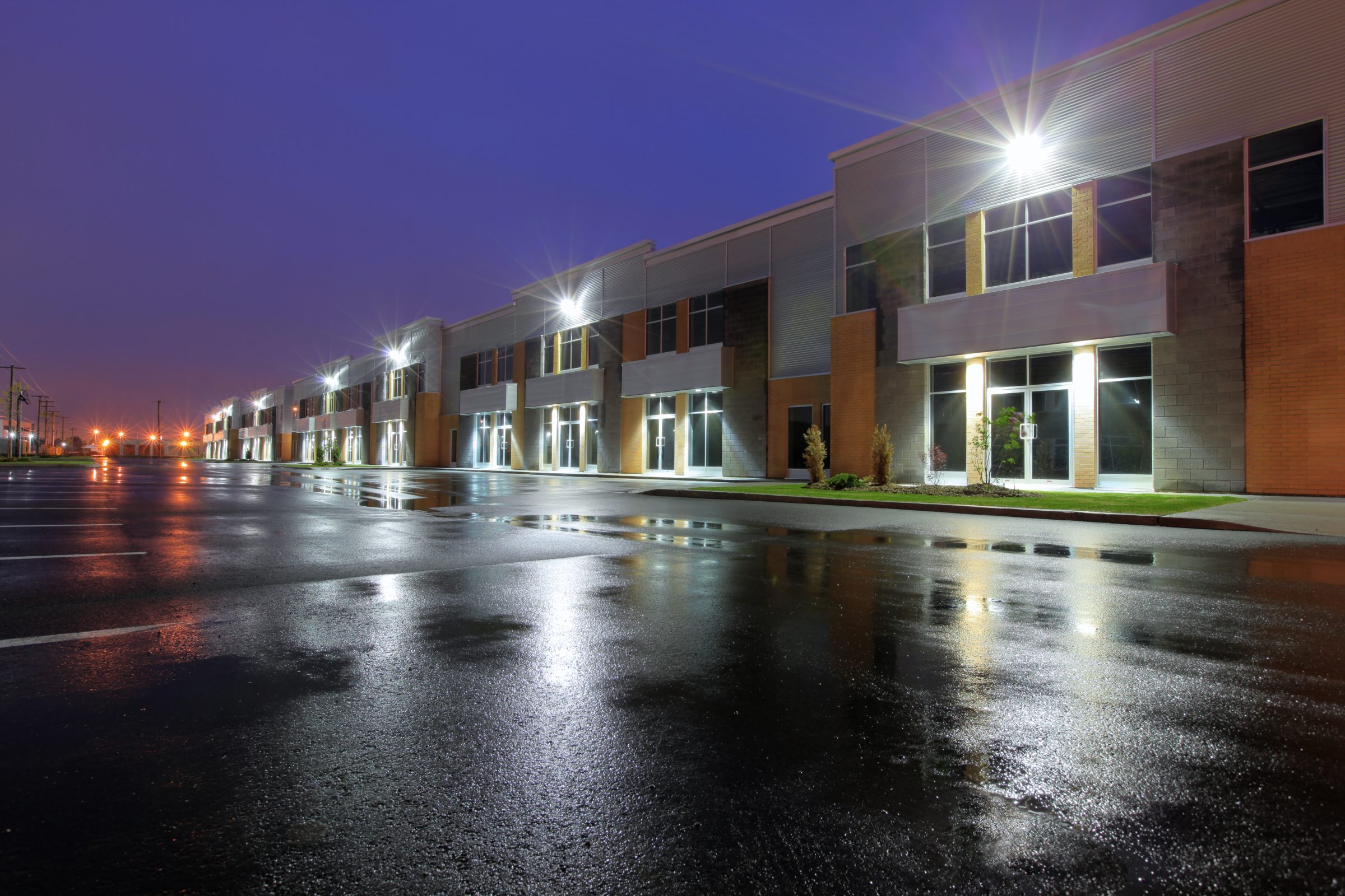Modern warehouse building with lights at night