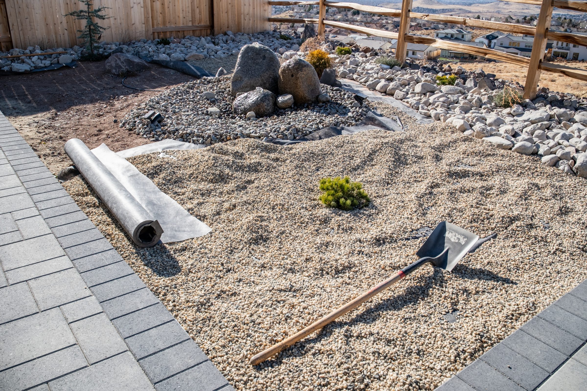 Backyard landscaping with gravel and shovel