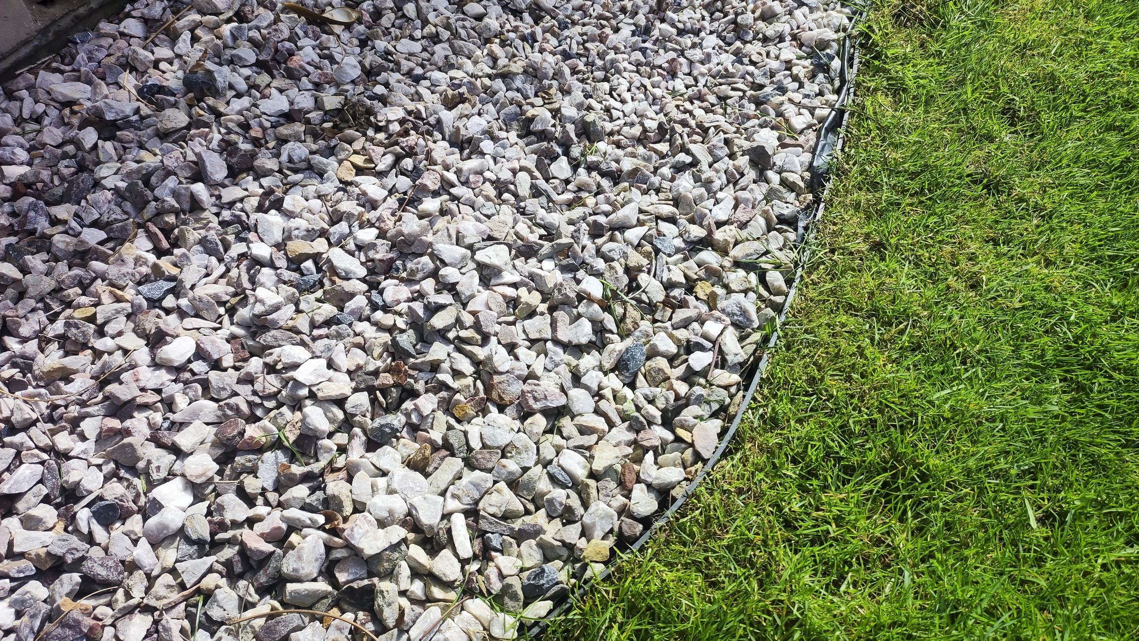 Colorful stones and green grass border